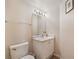 Compact half-bathroom featuring a white vanity and essential fixtures at 7945 Delbonita Ave, Las Vegas, NV 89147
