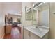 Bathroom vanity featuring a sink, mirror, and lighting fixtures at 7945 Delbonita Ave, Las Vegas, NV 89147