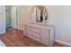Bedroom featuring a dresser with round mirror and wood laminate flooring at 7945 Delbonita Ave, Las Vegas, NV 89147