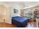 Bedroom with hardwood flooring and a ceiling fan, with natural lighting from a window at 7945 Delbonita Ave, Las Vegas, NV 89147
