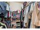 Walk-in closet with clothes hanging and folded on shelves at 7945 Delbonita Ave, Las Vegas, NV 89147