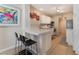 Bright kitchen with white cabinets, stainless appliances, and cozy breakfast bar at 7945 Delbonita Ave, Las Vegas, NV 89147