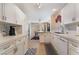 Spacious kitchen with white cabinets, stainless sink, and open layout to dining area at 7945 Delbonita Ave, Las Vegas, NV 89147