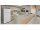 Clubhouse kitchen featuring a full-size refrigerator, stove, and ample counter space at 7945 Delbonita Ave, Las Vegas, NV 89147