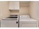 Laundry room with front load washer and top load dryer at 7945 Delbonita Ave, Las Vegas, NV 89147