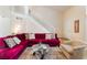 Bright living room featuring a red sofa, staircase, and neutral decor at 7945 Delbonita Ave, Las Vegas, NV 89147