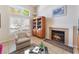 Cozy living area with fireplace, bookshelf, and bright windows at 7945 Delbonita Ave, Las Vegas, NV 89147