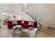 Inviting living room featuring a cozy red sectional and staircase leading to the upper level at 7945 Delbonita Ave, Las Vegas, NV 89147