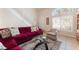 Inviting living room with red sofa, staircase and light-filled windows at 7945 Delbonita Ave, Las Vegas, NV 89147
