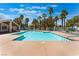 Community swimming pool with mature palm trees and an adjacent covered area at 7945 Delbonita Ave, Las Vegas, NV 89147