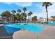 Inviting community pool with clear blue water and surrounding palm trees at 7945 Delbonita Ave, Las Vegas, NV 89147