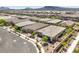An aerial view showcases a residential neighborhood with well-maintained homes and manicured landscaping in a planned community at 797 Drammatico Pl, Henderson, NV 89011
