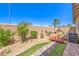A backyard features a small red bridge in a dry creek bed at 797 Drammatico Pl, Henderson, NV 89011