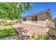 This serene backyard has a brick patio and lush green lawn, ideal for relaxing and enjoying outdoor living at 797 Drammatico Pl, Henderson, NV 89011
