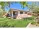 Great backyard featuring a covered patio, artificial turf, and a privacy fence at 797 Drammatico Pl, Henderson, NV 89011