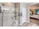Bright bathroom with glass shower doors and wood-look flooring at 797 Drammatico Pl, Henderson, NV 89011