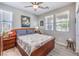 Comfortable bedroom featuring natural light, a ceiling fan and hardwood floors at 797 Drammatico Pl, Henderson, NV 89011