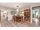 Dining room showcases modern light fixture and wood floors next to a beautiful display case at 797 Drammatico Pl, Henderson, NV 89011