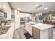 Bright kitchen features stainless steel appliances, white cabinetry, and a large kitchen island at 797 Drammatico Pl, Henderson, NV 89011