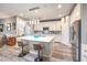 Bright kitchen with stainless appliances, white cabinets, pendant lighting and island with seating at 797 Drammatico Pl, Henderson, NV 89011
