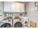 A laundry room has a washer, dryer, storage, and utility sink at 797 Drammatico Pl, Henderson, NV 89011