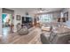 Inviting living room features a large window, ceiling fan, and wood-look flooring at 797 Drammatico Pl, Henderson, NV 89011