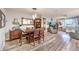Open concept living space features a dining area, living room, and wood-look flooring at 797 Drammatico Pl, Henderson, NV 89011