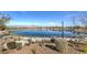 Scenic community pond surrounded by walking paths, greenery, and mountain views at 797 Drammatico Pl, Henderson, NV 89011