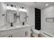 Bright bathroom featuring double sinks, quartz countertop and a shower with black tile at 824 N 20Th St, Las Vegas, NV 89101