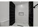 Bright bathroom featuring a shower with black tile, marble tile and a shower niche at 824 N 20Th St, Las Vegas, NV 89101
