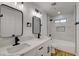 Bright bathroom featuring double sinks, quartz countertop and a tub with white marble tile at 824 N 20Th St, Las Vegas, NV 89101
