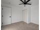 Bright bedroom featuring neutral carpet, white walls, closet and modern ceiling fan at 824 N 20Th St, Las Vegas, NV 89101
