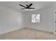 Bright bedroom featuring neutral carpet, white walls, and a modern ceiling fan at 824 N 20Th St, Las Vegas, NV 89101