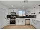 Well-designed kitchen features stainless steel appliances, black subway tile backsplash, and white cabinets at 824 N 20Th St, Las Vegas, NV 89101
