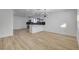 Open concept living area with bright white walls, wood-look flooring, and modern light fixture at 824 N 20Th St, Las Vegas, NV 89101