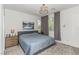 Comfortable bedroom with natural light, neutral walls, and a stylish light fixture at 8242 Vino Merlot Ave, Las Vegas, NV 89113