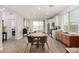 Open floor plan features a dining area adjacent to the kitchen with stainless steel appliances and natural light at 8242 Vino Merlot Ave, Las Vegas, NV 89113