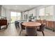Bright dining area connects to a modern kitchen with a large island, stainless steel appliances, and backyard access at 8242 Vino Merlot Ave, Las Vegas, NV 89113