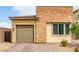 Charming home with a stone facade, neutral stucco, and a paved driveway at 8242 Vino Merlot Ave, Las Vegas, NV 89113