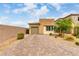 Inviting home exterior with a paved driveway, stone accents, and well-maintained landscaping at 8242 Vino Merlot Ave, Las Vegas, NV 89113