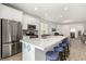 Modern kitchen with white cabinetry, stainless steel appliances, and a spacious island with seating at 8242 Vino Merlot Ave, Las Vegas, NV 89113