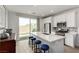 Modern kitchen with a large center island, stainless steel appliances, and easy access to the outdoor space at 8242 Vino Merlot Ave, Las Vegas, NV 89113