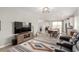 Inviting living room with wood-look floors, and an adjacent dining area and modern kitchen at 8242 Vino Merlot Ave, Las Vegas, NV 89113