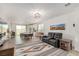 Open-concept living space features dining area, modern lighting, stainless appliances, and access to the backyard at 8242 Vino Merlot Ave, Las Vegas, NV 89113