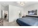 Comfortable main bedroom with en-suite bathroom, neutral walls, and soft natural light at 8242 Vino Merlot Ave, Las Vegas, NV 89113