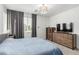 Serene main bedroom with neutral tones, soft lighting, and ample closet space at 8242 Vino Merlot Ave, Las Vegas, NV 89113