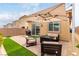 Outdoor patio is furnished with a modern outdoor furniture set and umbrella at 8242 Vino Merlot Ave, Las Vegas, NV 89113