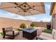 Cozy outdoor patio space with a fire pit, comfortable seating, and a privacy wall at 8242 Vino Merlot Ave, Las Vegas, NV 89113