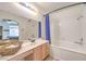 Bathroom featuring a shower-tub combo, bright lighting, and a vanity with ample counter space at 8408 Running Deer Ave # 201, Las Vegas, NV 89145