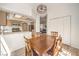 Cozy dining area with wood table, adjacent kitchen and view into the living room at 8408 Running Deer Ave # 201, Las Vegas, NV 89145